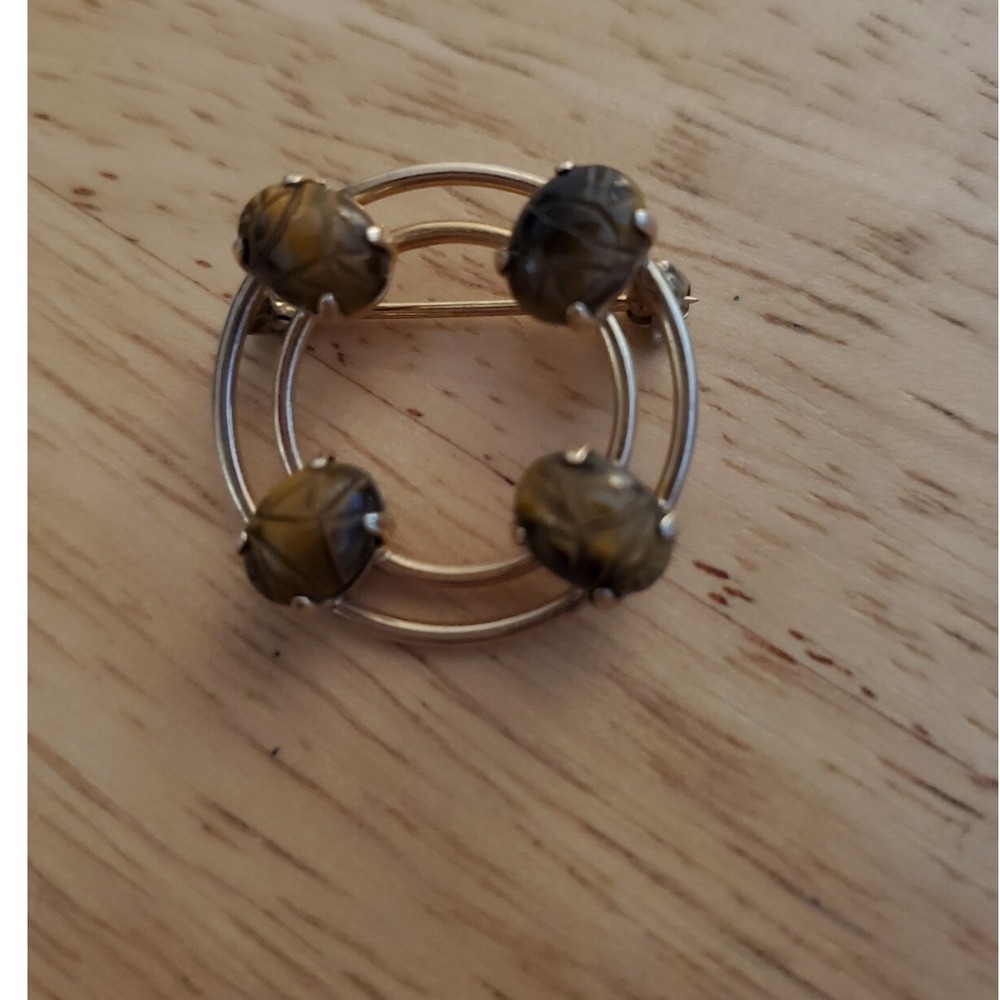 Vintage Monet circular gold tone brooch